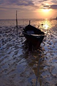 Boat in sea at sunset