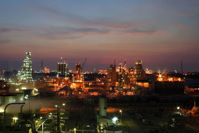 High angle view of illuminated city against sky at night