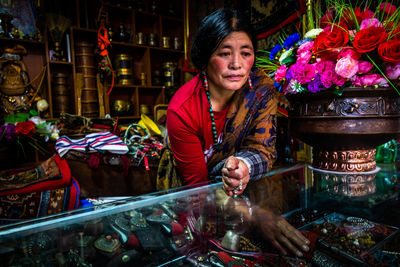 Portrait of woman selling goods in a shop