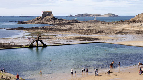 People on beach against sky