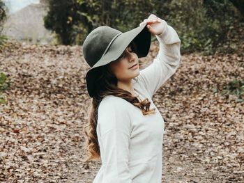 Full length of woman wearing hat standing outdoors