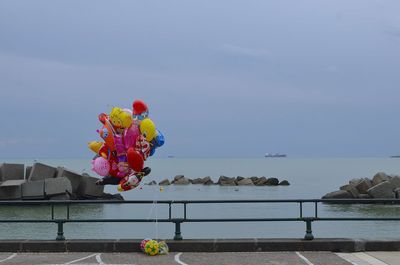 Air balls by sea against sky