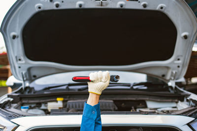 Cropped image of man holding car