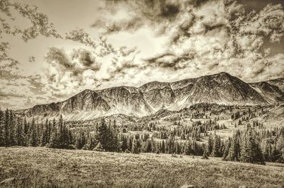 Scenic view of mountains against cloudy sky