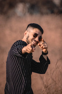 Young man wearing sunglasses standing outdoors