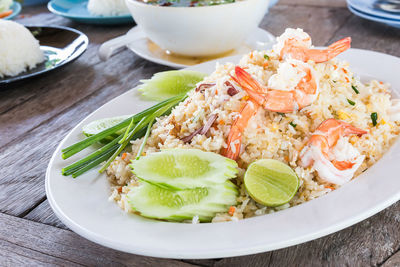 Fried rice with shrimp on the old wooden table