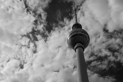 Low angle view of communications tower against sky in city