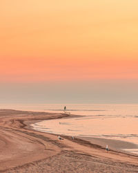 Scenic view of beach against sky during sunset