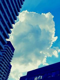 Low angle view of building against cloudy sky