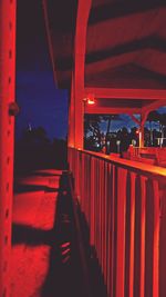 Illuminated red building against sky at night