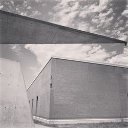 Low angle view of building against cloudy sky