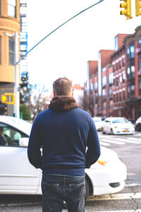 Rear view of man standing on road