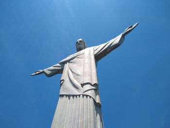 Low angle view of statue against blue sky