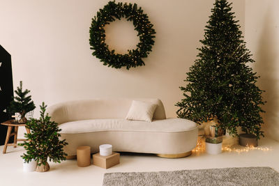 Christmas festive interior of a decorated cozy living room with a sofa at home