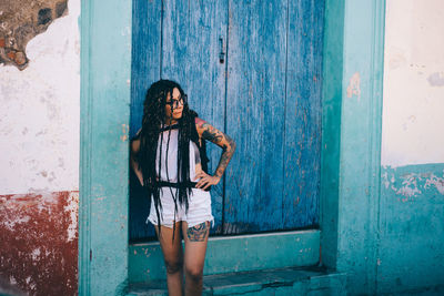 Woman standing against door