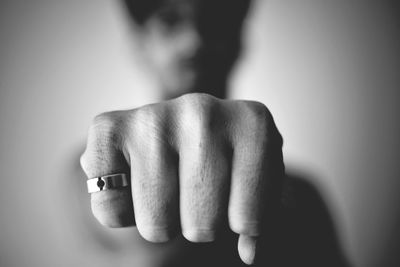 Close-up of human hand against gray background