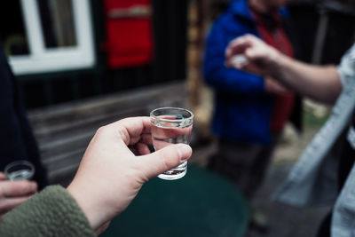 Midsection of man drinking glass