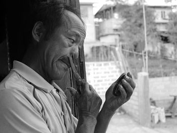 Portrait of man holding camera