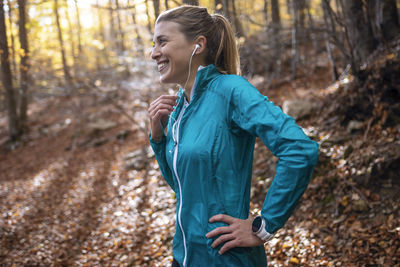 Full length of woman standing in forest