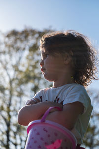 Low angle view of girl looking at camera