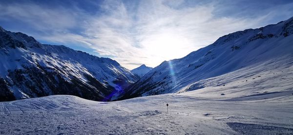 Scenic view of snowcapped mountains against sky