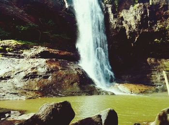 Scenic view of river flowing through rocks