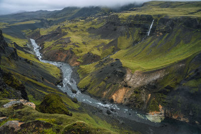 Iceland landscape of highland valley and river fossa with blue water stream, south iceland