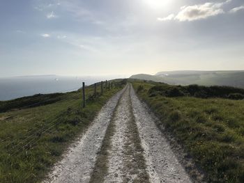 Empty road along countryside landscape