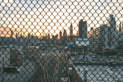 Close-up of chainlink fence against building