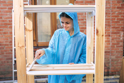 Portrait of young woman standing in workshop