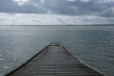 Pier over sea against sky
