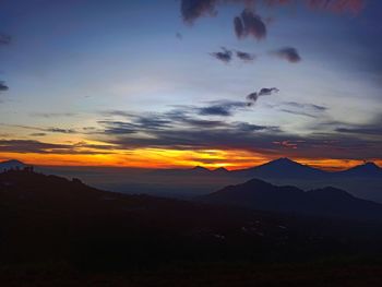 Scenic view of silhouette mountains against sky during sunset