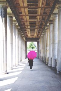 Rear view of woman standing in corridor