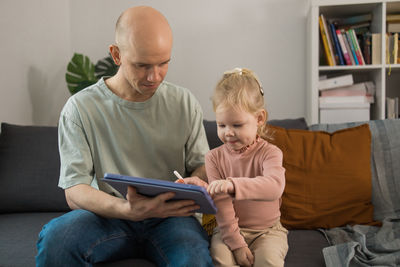 Boy using digital tablet at home