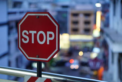 Close-up of stop sign with buildings in background