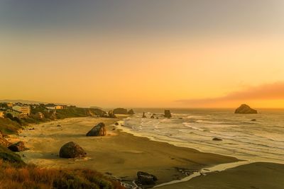 Scenic view of sea against clear sky during sunset