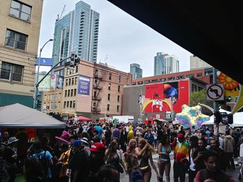 People on city street amidst buildings