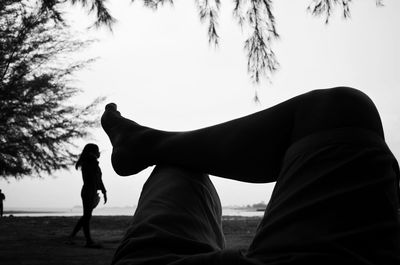 Low angle view of silhouette people against clear sky