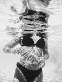 Low section of woman swimming in sea