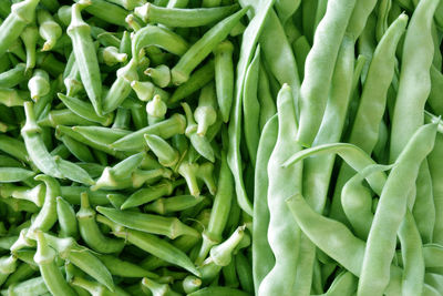 Fresh green okra and beans as background