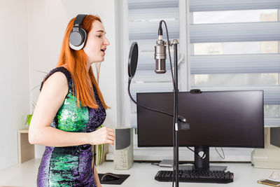Side view of woman in recording studio