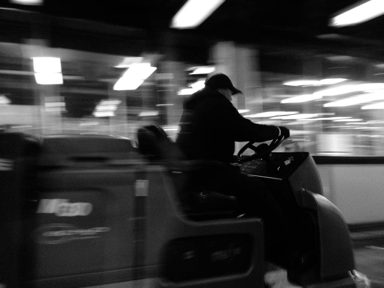 indoors, transportation, men, lifestyles, illuminated, mode of transport, public transportation, person, travel, blurred motion, leisure activity, on the move, rear view, land vehicle, unrecognizable person, passenger, silhouette