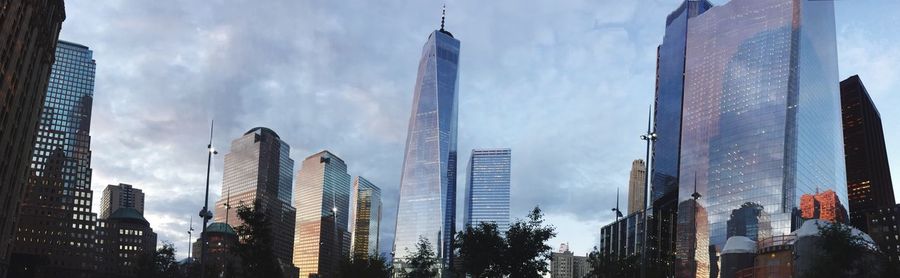 Low angle view of buildings against cloudy sky