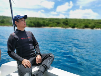 Sitting relax before going diving on a beautiful day  on the boat in bali strait 21 december 2021