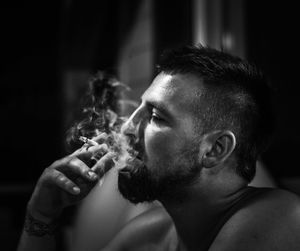 Portrait of man smoking cigarette