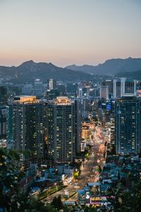 High angle view of illuminated cityscape against clear sky