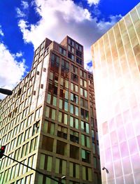 Low angle view of modern building against cloudy sky