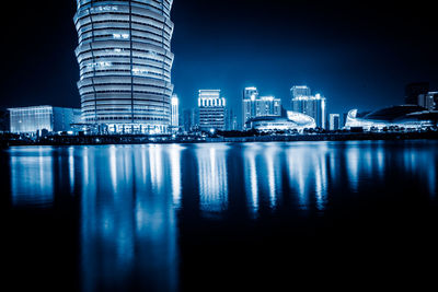 Reflection of illuminated buildings in city at night