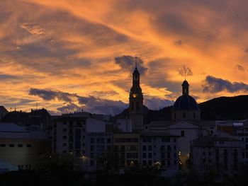 Buildings in city against sky during sunset