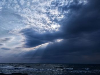 Scenic view of sea against storm clouds